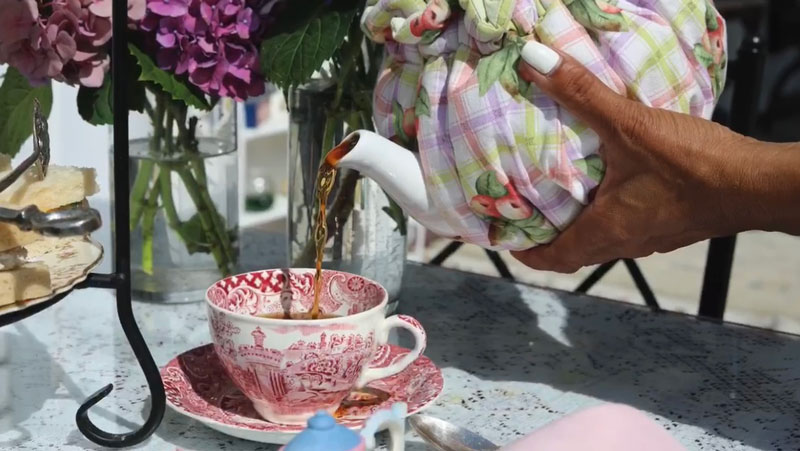 Pouring a cup of tea from a teapot